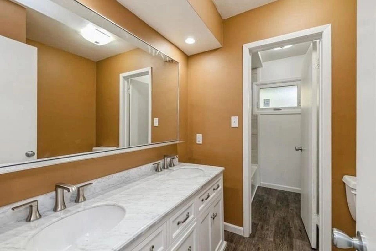 Bathroom with a double vanity and a large mirror